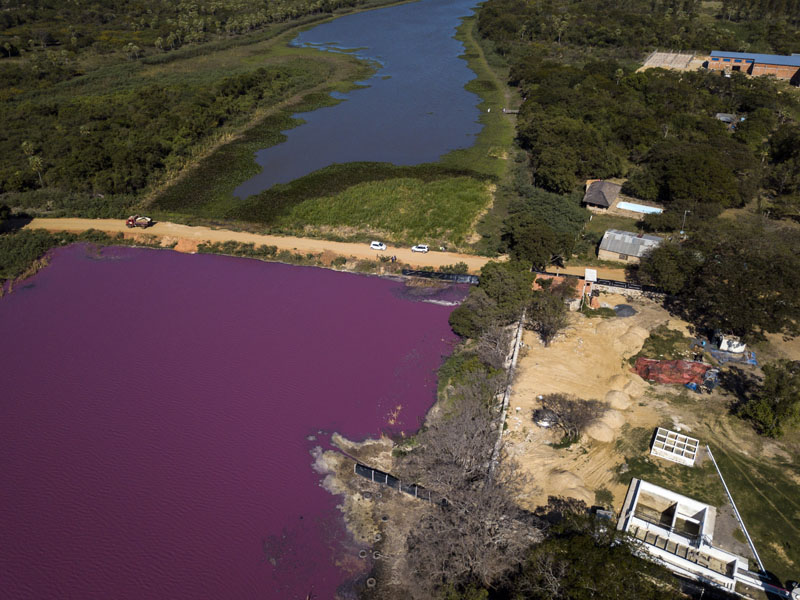A road divides the Cerro Lagoon, where the water below the road is colored and the Waltrading S.A. tannery stands on the bank, bottom right, in Limpio, Paraguay, Wednesday, Aug. 5, 2020. Photo: AP