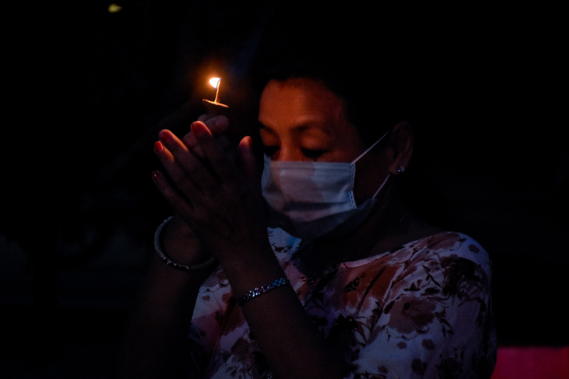 A person offers morning prayer to Rato Machhindranath on Monday amid the safety restrictions imposed by district officials to contain the spread of coronavirus. Photo: Naresh Shrestha/THT