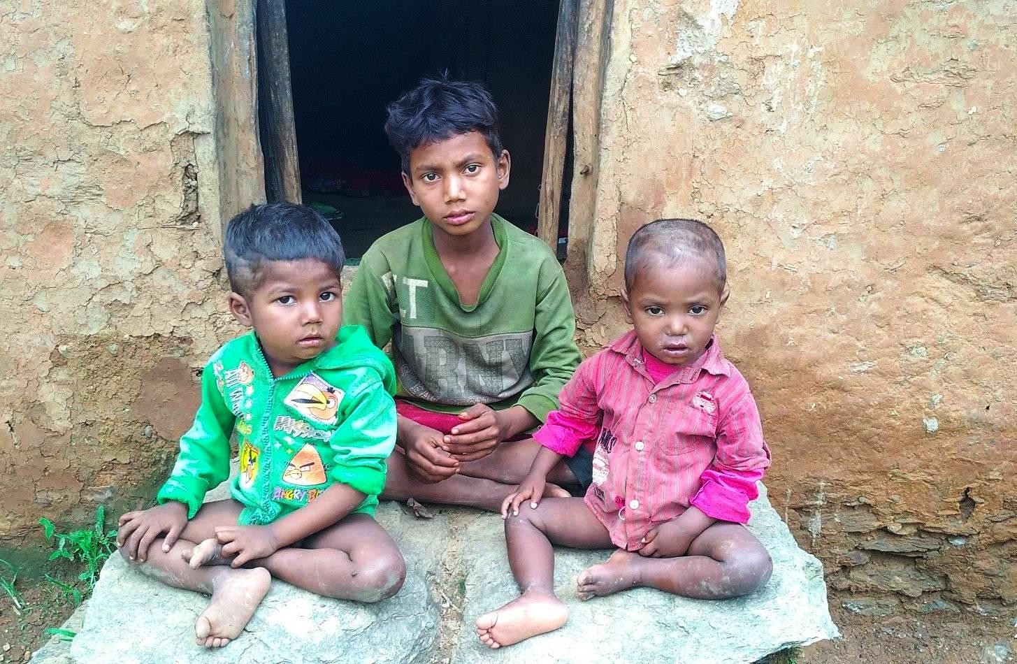 Three stranded kids sit in-front of a house in Doti District as captured on Sunday August 09, 2020. Photo: Tekendra Deuba/THT