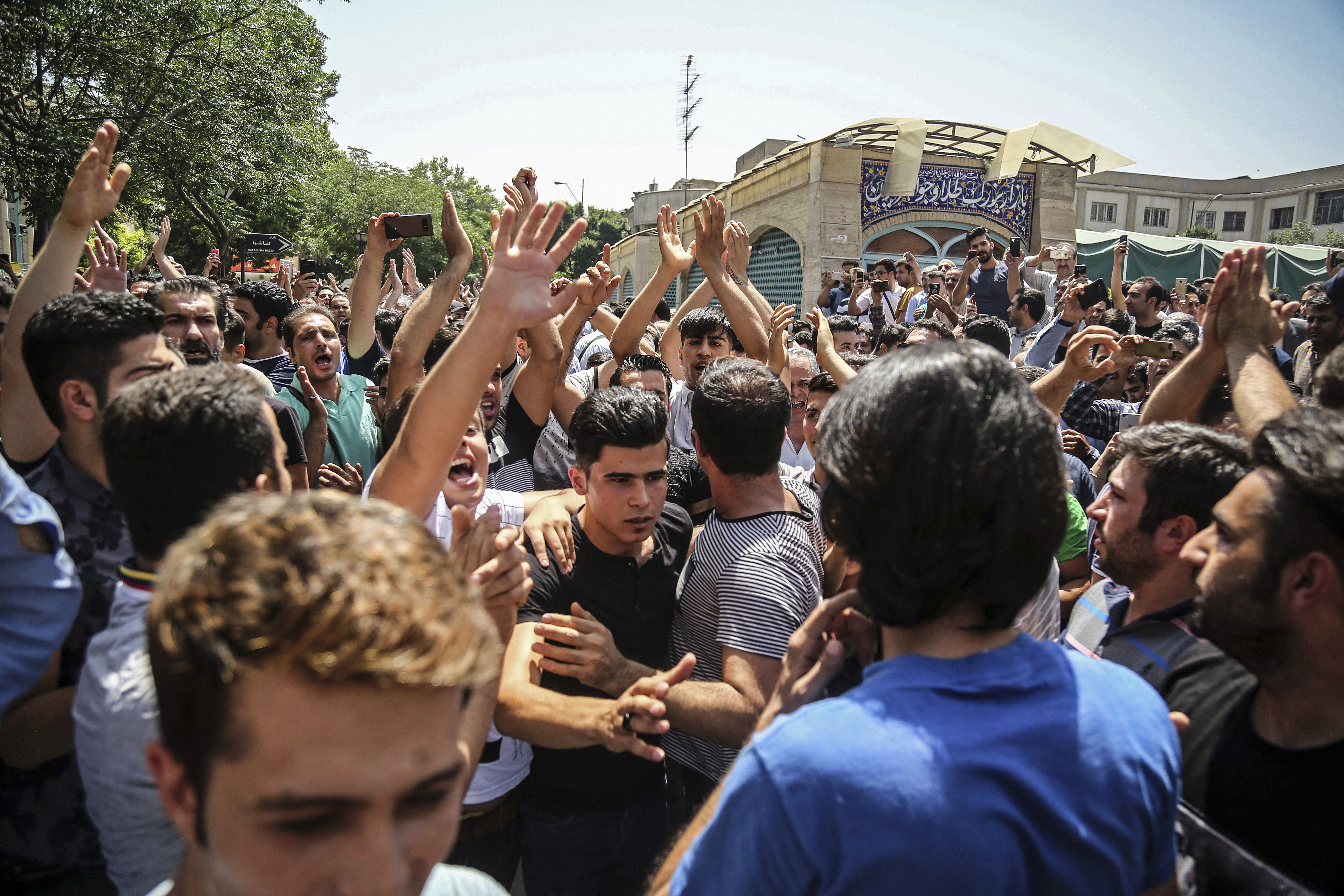 FILE - In this June 25, 2018 file photo, a group of protesters chant slogans at the main gate of the Old Grand Bazaar, in Tehran, Iran. On Saturday, Sept. 5, 2020, Iran broadcast the televised confession of a wrestler facing the death penalty after a tweet from President Donald Trump criticizing the case, a segment that resembled hundreds of other suspected coerced confessions aired over the last decade in the Islamic Republic. The case of 27-year-old Navid Afkari has drawn the attention of a social media campaign that portrays him and his brothers as victims targeted over participating in protests against Iran's Shiite theocracy in 2018. Photo: AP