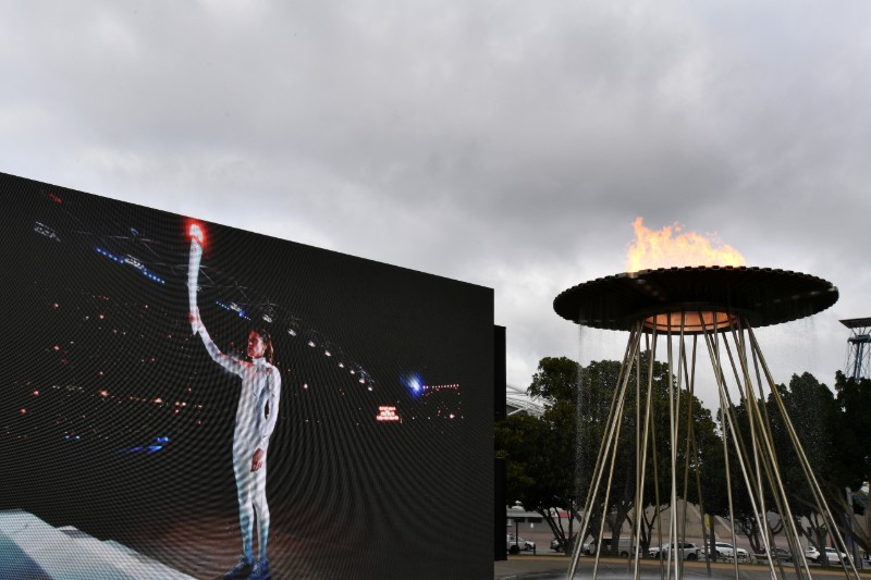 A video screen shows Olympian Cathy Freeman lighting the Olympic Cauldron as part of the 20th anniversary celebrations of the Sydney 2000 Olympic Games Opening Ceremony at Cathy Freeman Park in Sydney, Australia, September 15, 2020. Photo: AAP Image/Dean Lewins/via Reuters
