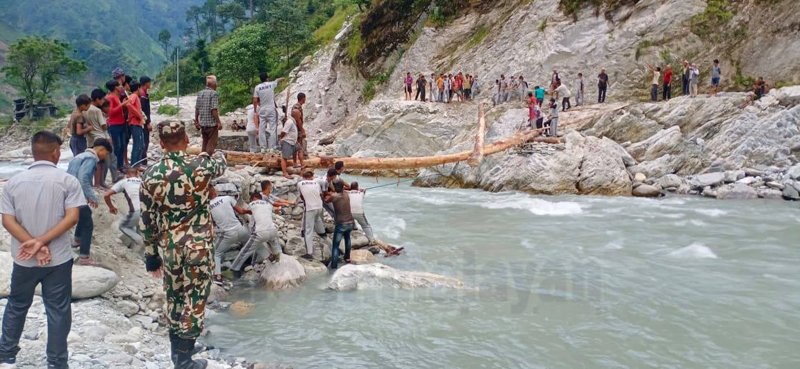 Nepal Army along with locals construct a temporary wooden bridge over Budhiganga River in Jadang, Bajura district, on Thursday, September 10, 2020. Photo: Prakash Singh/THT