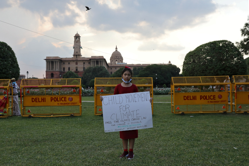 Licypriya Kangujam, 8, India's young climate activist, holds a poster during a protest demanding to pass a climate change law outside the parliament in New Delhi, India, September 23, 2020. Picture taken September 23, 2020. Photo: Reuters