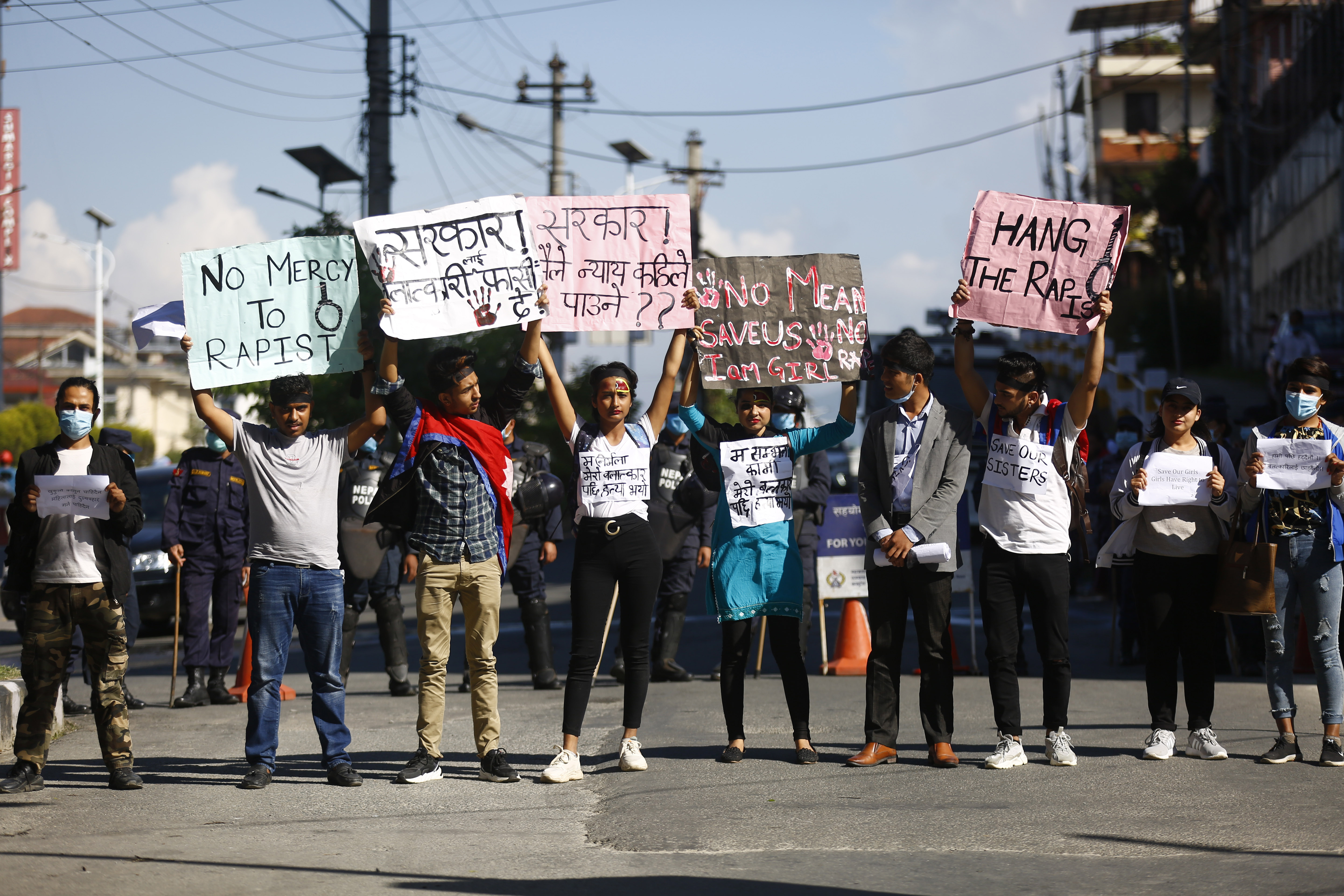 Students hold placards in protest of brutal rape of a 12-year-old girl in Bajhang district, at Maitighar, Kathmandu, on Sunday, September 27, 2020. Photo: Skanda Gautam/THT 