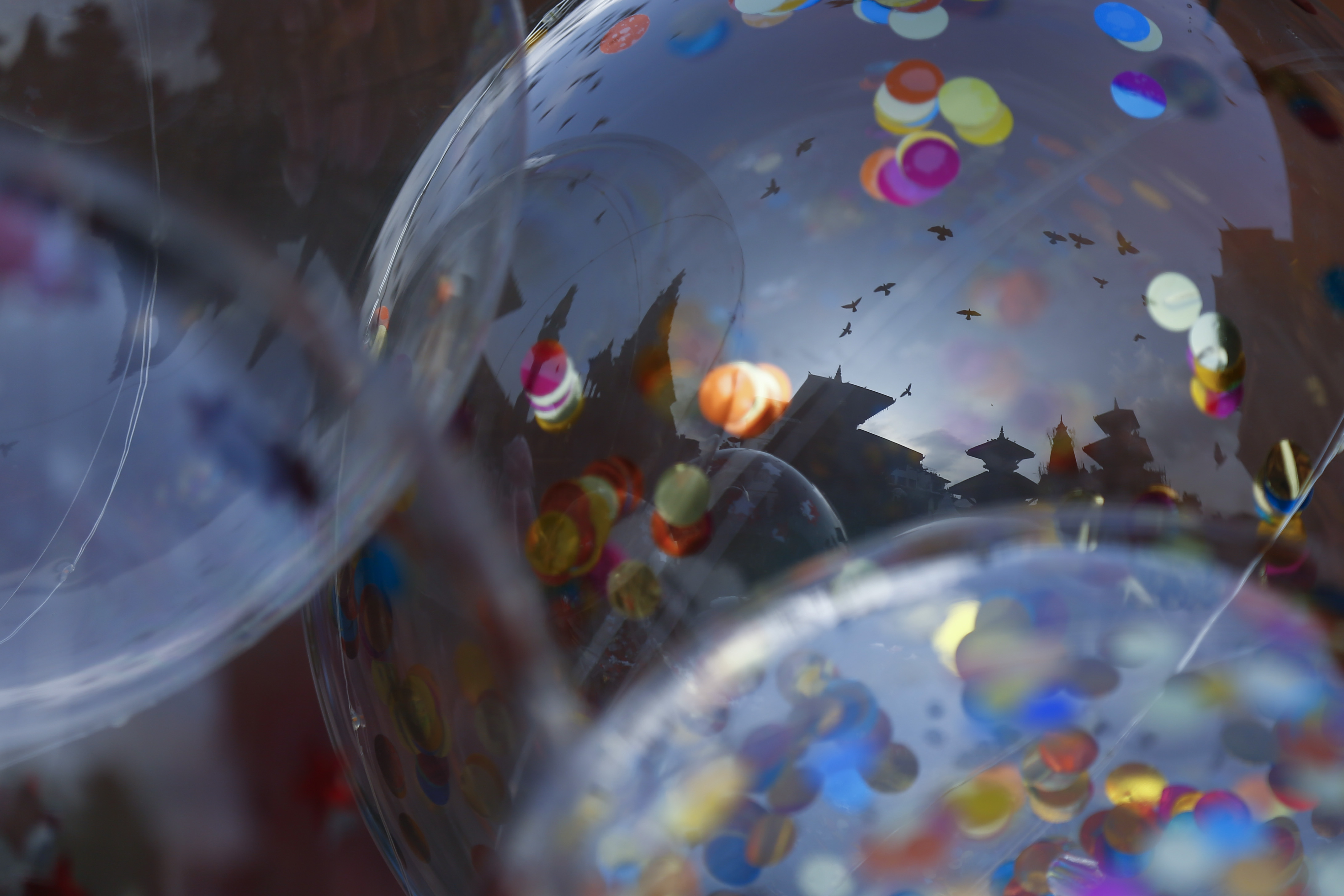 Temples of Patan Durbar Square, a UNESCO World Heritage site reflected on balloons put up for sale in Lalitpur, on Wednesday, September 30, 2020. Photo: Skanda Gautam/THT