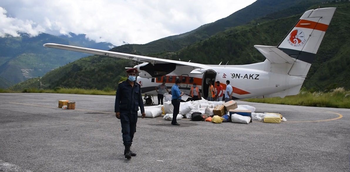 Food items and liquor being taken out of an aircraft at Kolti Airport, Bajura, on Tuesday. Photo: THT