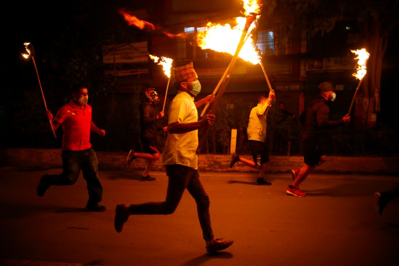 Supporters of Kulman Ghising, now-retired Managing Director of Nepal Electricity Authority, take part in a torch protest in Kathmandu on Wednesday demanding his reappointment. Riot police had chased away people who had gathered for a rally supporting Ghising's reappointment in the afternoon. Photo: Skanda Gautam/ THT