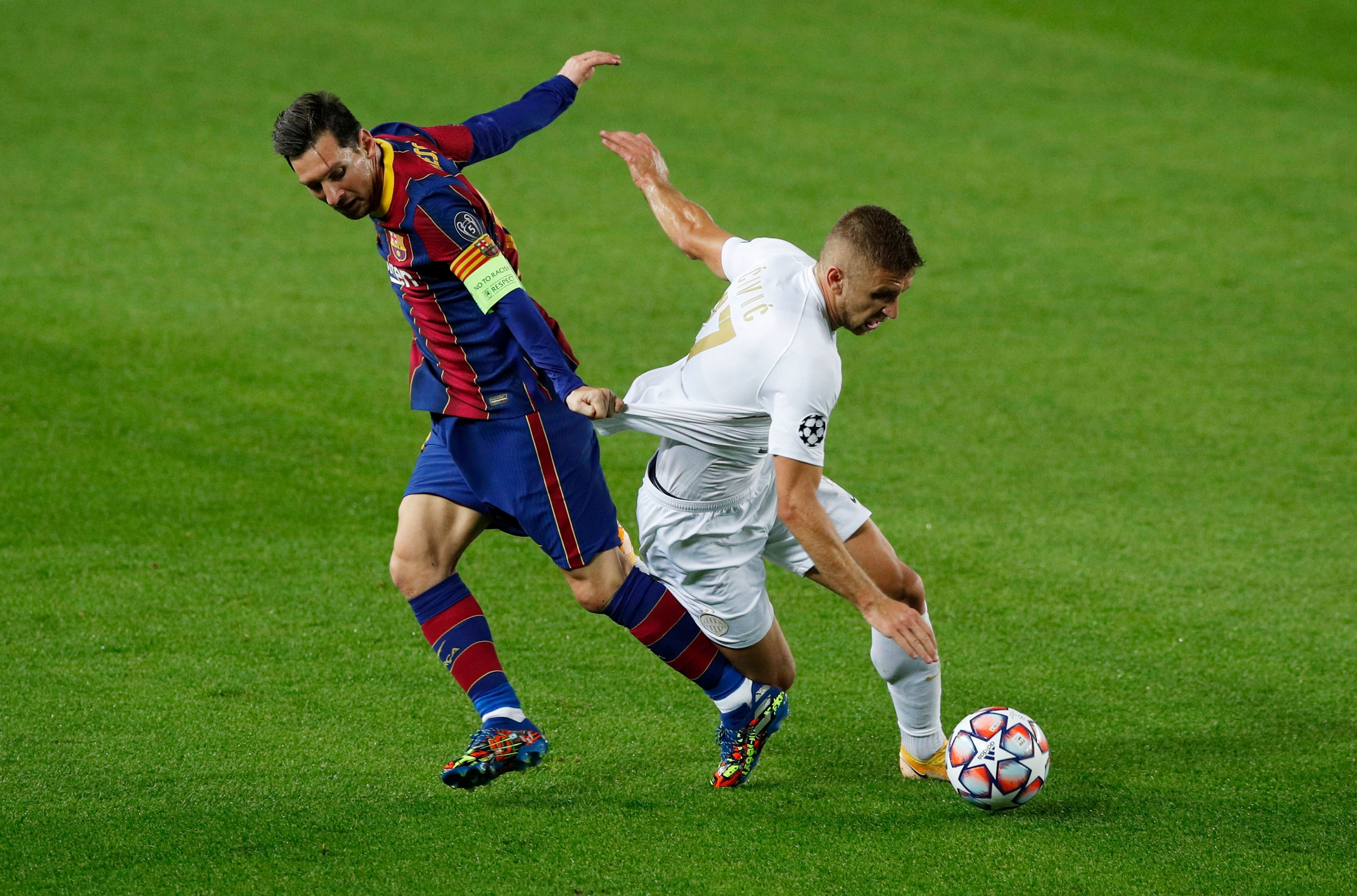 FC Barcelona's Lionel Messi in action with Ferencvaros' Eldar Civic nduring the Champions League Group G match between FC Barcelona and Ferencvaros, at Camp Nou, in Barcelona, Spain, on October 20, 2020. Photo: Reuters