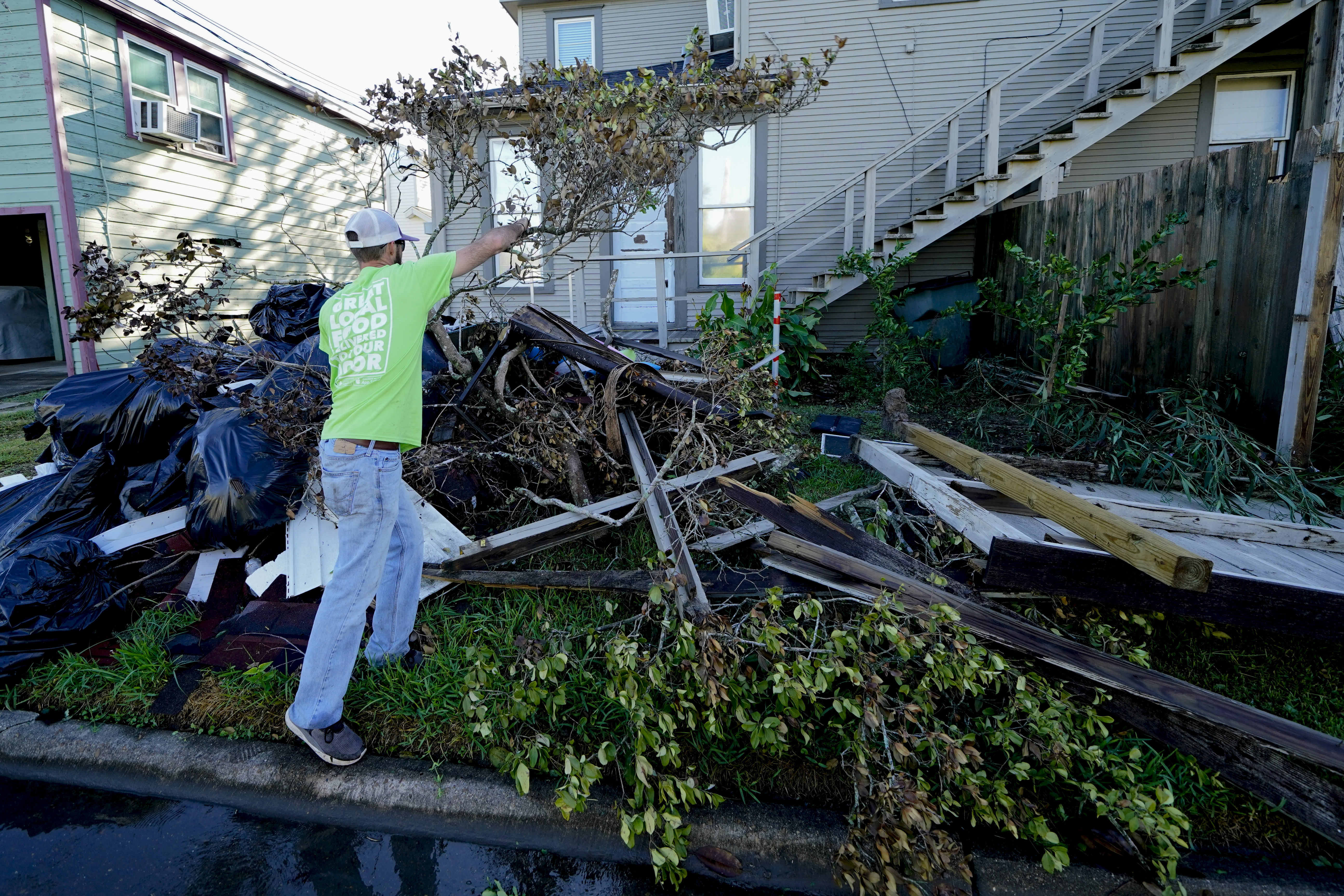 Caleb Cormier moves debris after Hurricane Delta moved through, Saturday, Oct. 10, 2020, in Lake Charles, La. Delta hit as a Category 2 hurricane with top winds of 100 mph (155 kph) before rapidly weakening over land. Photo: AP
