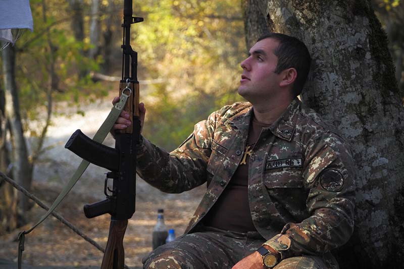 A volunteer soldier holds his Kalashnikov weapon as he rests near a front line at a military base during a military conflict in the separatist region of Nagorno-Karabakh, on Tuesday, October 27, 2020. Photo: AP