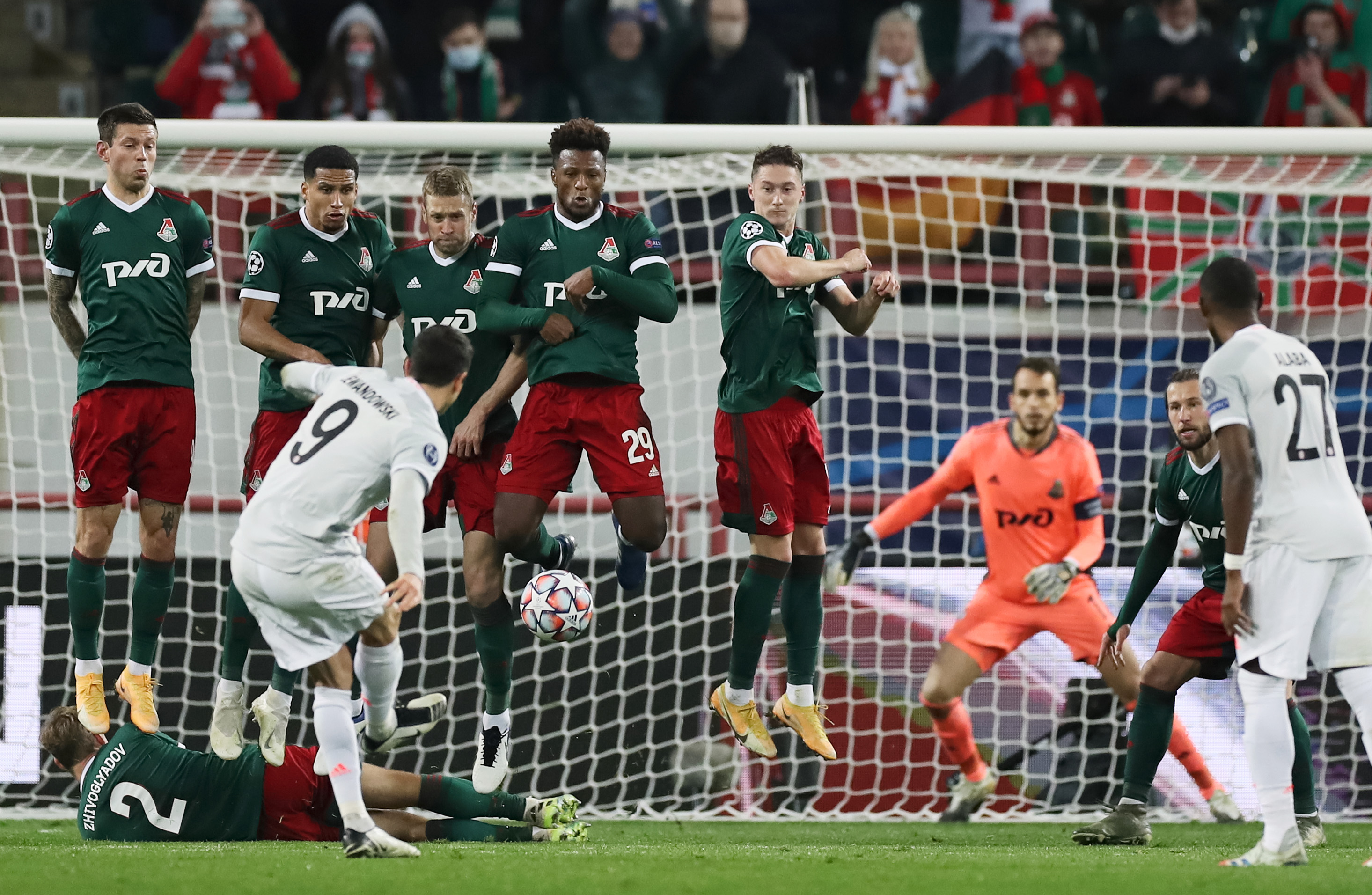 Bayern Munich's Robert Lewandowski shoots at goal from a free kick as Lokomotiv Moscow's Dmitri Zhivoglyadov lies on the ground behind the defensive wall during their Champions League Group A match at RZD Arena, in Moscow, Russia, on  October 27, 2020. Photo: Pool via Reuters