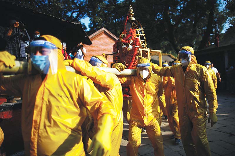 Devotees wearing personal protective equipment carrying the idol of Lord Bhairav in Kathmandu, on Wednesday, October 21, 2020. Photo: Skanda Gautam/THT