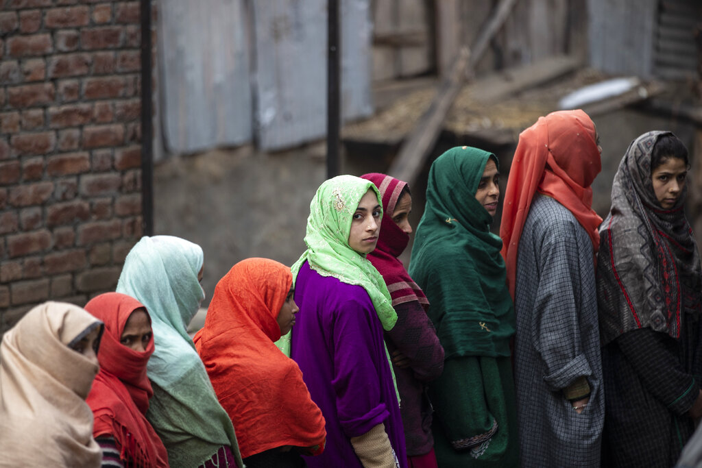 Kashmiris stand in a queue to cast their votes during the first phase of District Development Councils election on the outskirts of Srinagar, Indian controlled Kashmir, Saturday, November 28, 2020. Photo: AP