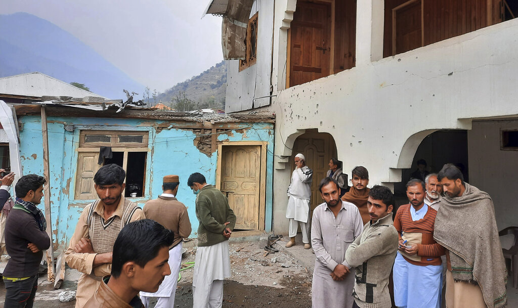 Local residents gather in a partially damage house caused by shelling of Indian forces at a village in Neelum Valley, situated at the Line of Control in Pakistan-administered Kashmir, Friday, November 13, 2020. Photo: AP