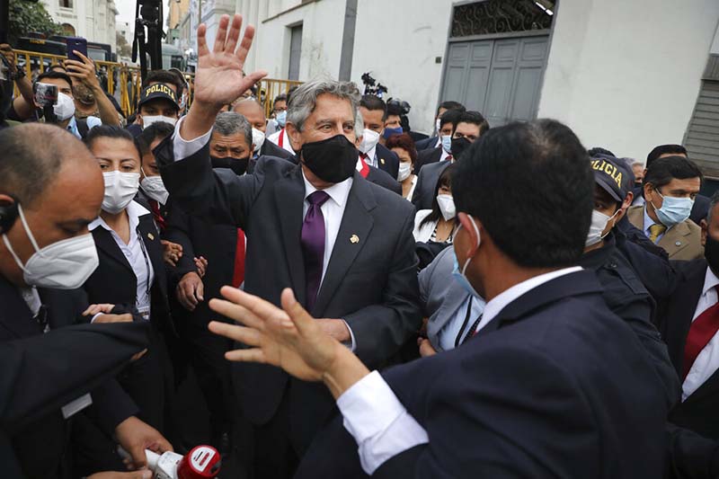 Peru's new interim President Francisco Sagasti waves to the crowd after he was designated by Congress to lead the nation, in Lima, Peru, Monday, Nov. 16, 2020. Congress chose Sagasti to become the nation's third president in the span of a week after Congress ousted Martin Vizcarra and the following protests forced his successor Manuel Merino to resign. (AP Photo/Rodrigo Abd)