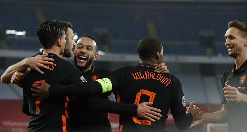 Netherlands' Steven Berghuis (left)  Memphis Depay, laughing, and Luuk de Jong (right) celebrate with Georginio Wijnaldum who scored his side's second goal during the Nations League soccer match between Poland and The Netherlands at Silesian Stadium in Chorzow, Poland, on Wednesday, November 18, 2020. Photo: AP