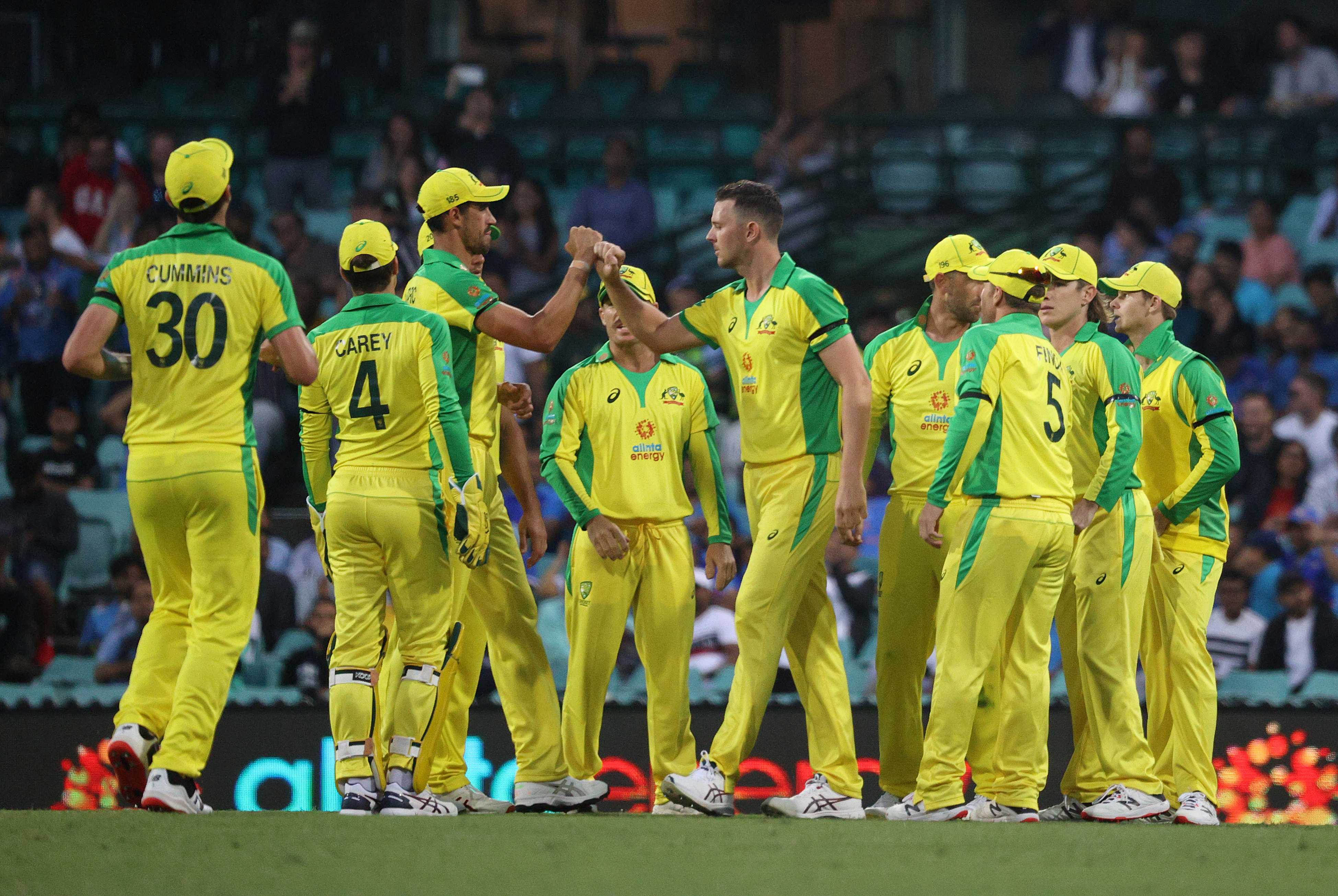 Australia's Josh Hazlewood celebrates with teammates after taking the wicket of India's Mayank Agarwal. Photo: Reuters