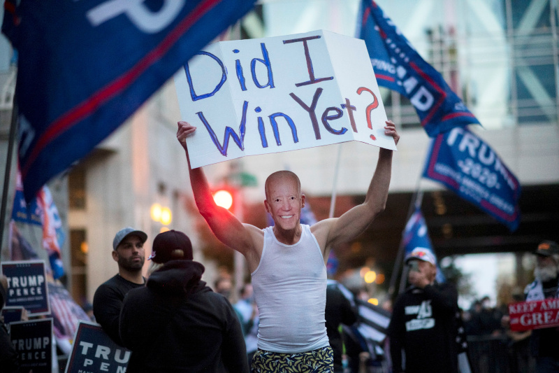 Trump supporter carries a sign while wearing a mask of U.S. Democratic presidential nominee Joe Biden during a protest outside of the Philadelphia Convention Center, where votes are still being counted two days after the presidential election, in Philadelphia, Pennsylvania, U.S. November 5, 2020.  Photo: Reuters