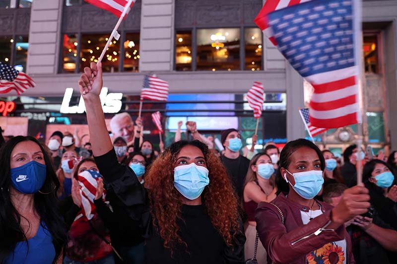 People react as they watch a speech by Democratic US presidential nominee Joe Biden in Times Square after news media announced he has won the 2020 US presidential election in Manhattan, New York, US, on November 7, 2020. Photo: Reuters
