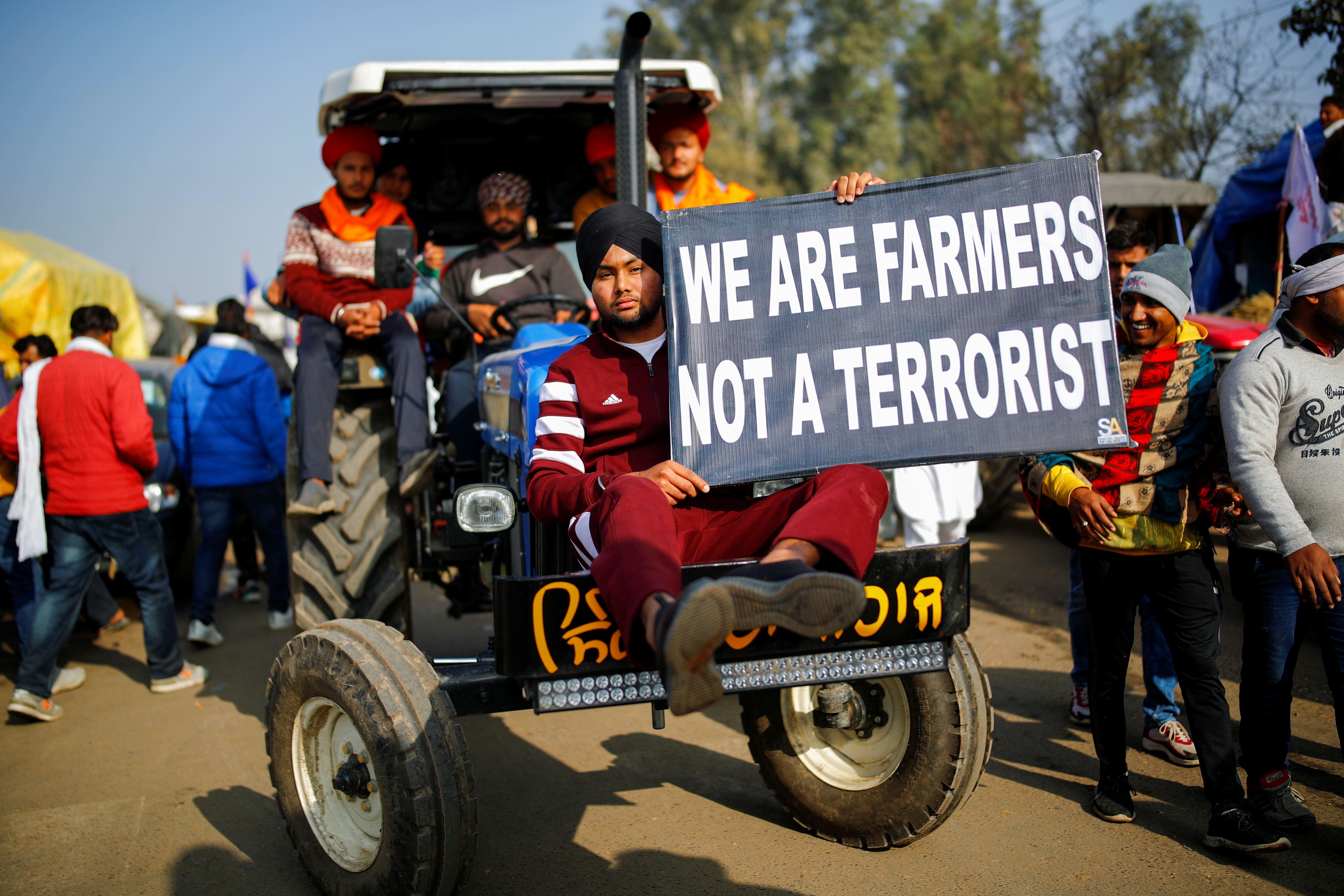 Farmers arrive in a tractor to attend a protest against the newly passed farm bills at Singhu border near New Delhi, India, December 14, 2020. Photo: Reuters