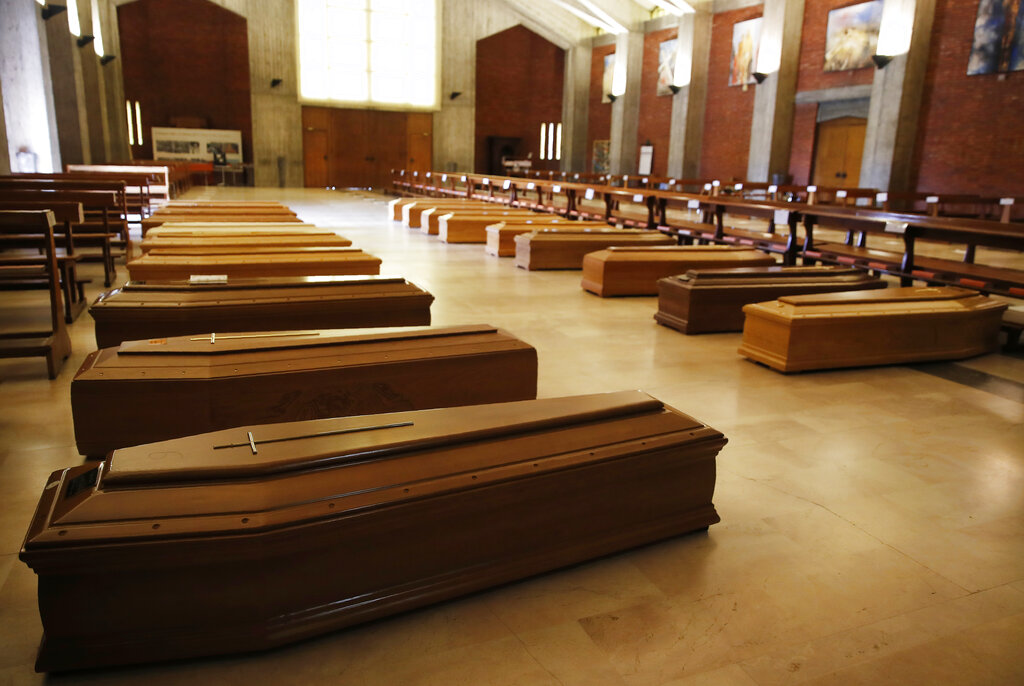 In this March 26, 2020 file photo, coffins are lined up on the floor in the San Giuseppe church in Seriate, one of the areas worst hit by coronavirus, near Bergamo, Italy, waiting to be taken to a crematorium. Italy is poised to reclaim the dishonor of reporting the most coronavirus deaths in Europe, as the second surge ravages the countryu2019s disproportionately old population and exposes how public health shortfalls and delayed restrictions compounded a lack of preparedness going into the pandemic. Photo: AP