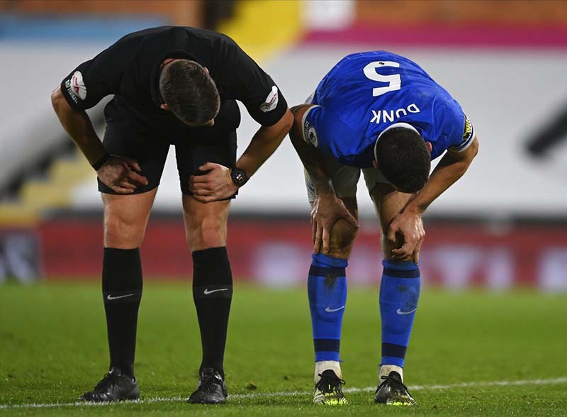 Brighton &amp; Hove Albion's Lewis Dunk is checked on by referee Robert Jones after sustaining an injury during the English Premier League soccer match between Fulham and Brighton and Hove Albion at Craven Cottage stadium in London, on Wednesday, December 16, 2020. Photo: Mike Hewitt/Pool via AP