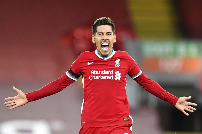 Liverpool's Roberto Firmino celebrates after scoruing his side's 2nd goal during their English Premier League soccer match between Liverpool and Tottenham Hotspur at Anfield in Liverpool, England, on Wednesday, December, 16, 2020. Photo: Peter Powell/ Pool via AP