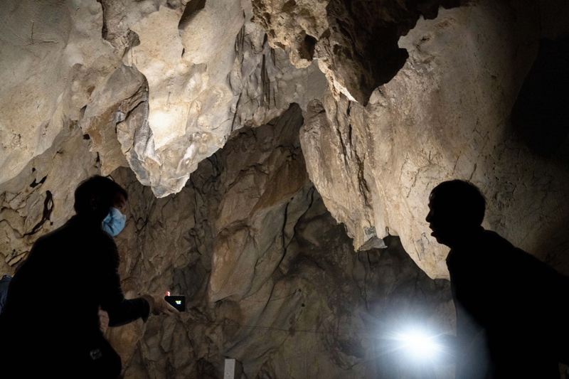 Visitors look inside the abandoned Wanling cave near Manhaguo village in southern China's Yunnan province on Wednesday, Dec. 2, 2020. Photo: AP