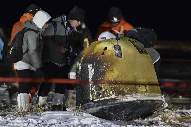 In this photo released by Xinhua News Agency, recovery crew members check on the capsule of the Chang'e 5 probe after its successful landed in Siziwang district, north China's Inner Mongolia Autonomous Region on Thursday, Dec. 17, 2020. A Chinese lunar capsule returned to Earth on Thursday with the first fresh samples of rock and debris from the moon in more than 40 years. Photo: Ren Junchuan/Xinhua via AP