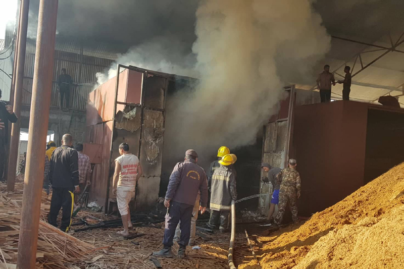 Locals and security personnel bring fire under control at the Namaste Ply Industry at Chaitubari, Birtamod-2 in Jhapa district, Friday, December 04, 2020. Photo: RSS