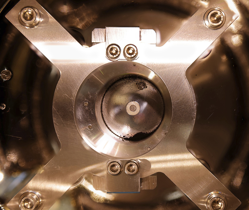 In this photo provided by the Japan Aerospace Exploration Agency (JAXA), soil samples are seen on the bottom of the capsule's sample-catcher, brought back by Hayabusa2, in Sagamihara, near Tokyo, Tuesday, Dec. 15, 2020. Photo: JAXA via AP