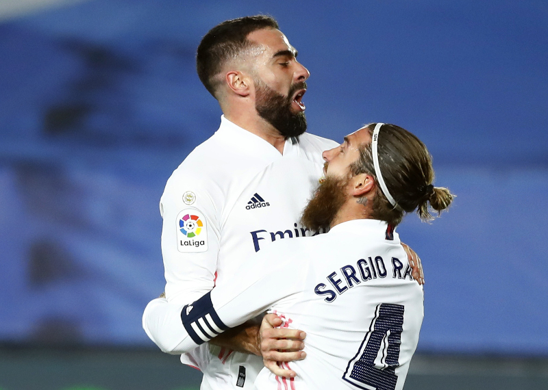 Real Madrid's Dani Carvajal celebrates with Sergio Ramos after Atletico Madrid's Jan Oblak scored an own goal during the La Liga Santander between Real Madrid and Atletico Madrid, at Estadio Alfredo Di Stefano, in  Madrid, Spain, on December 12, 2020. Photo: Reuters