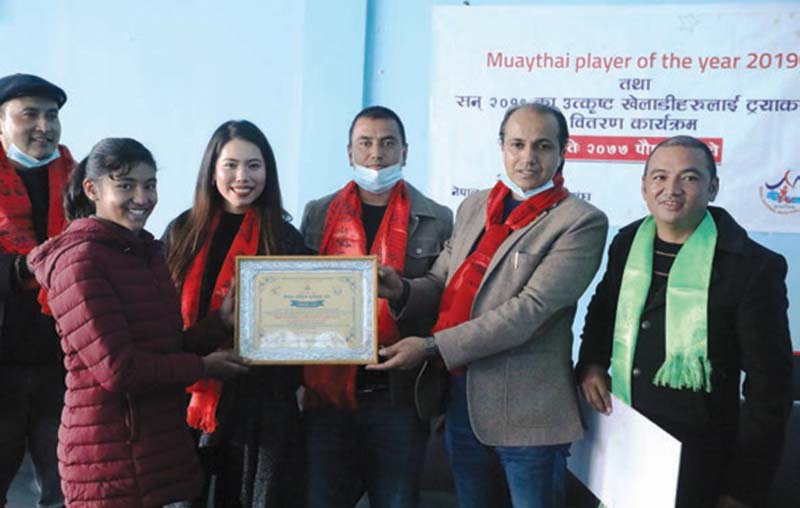Nepal National Muaythai Association felicitates Palistha Kakshyapati with the Player of the Year award, in Kathmandu, on Wednesday, Deember 30, 2020. Photo: THT