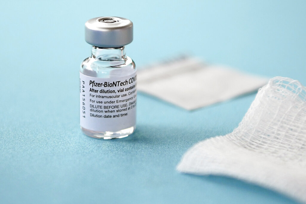 In this Monday, Dec. 14, 2020, file photo, a vial of the Pfizer-BioNTech vaccine for COVID-19 sits on a table at Hartford Hospital in Hartford, Conn. New research suggests that Pfizeru2019s COVID-19 vaccine can protect against a mutation found in two contagious variants of the coronavirus that erupted in Britain and South Africa. Those variants are causing global concern. They both share a common mutation called N501Y, a slight alteration on one spot of the spike protein that coats the virus. That change is believed to be the reason they can spread so easily. Photo: AP