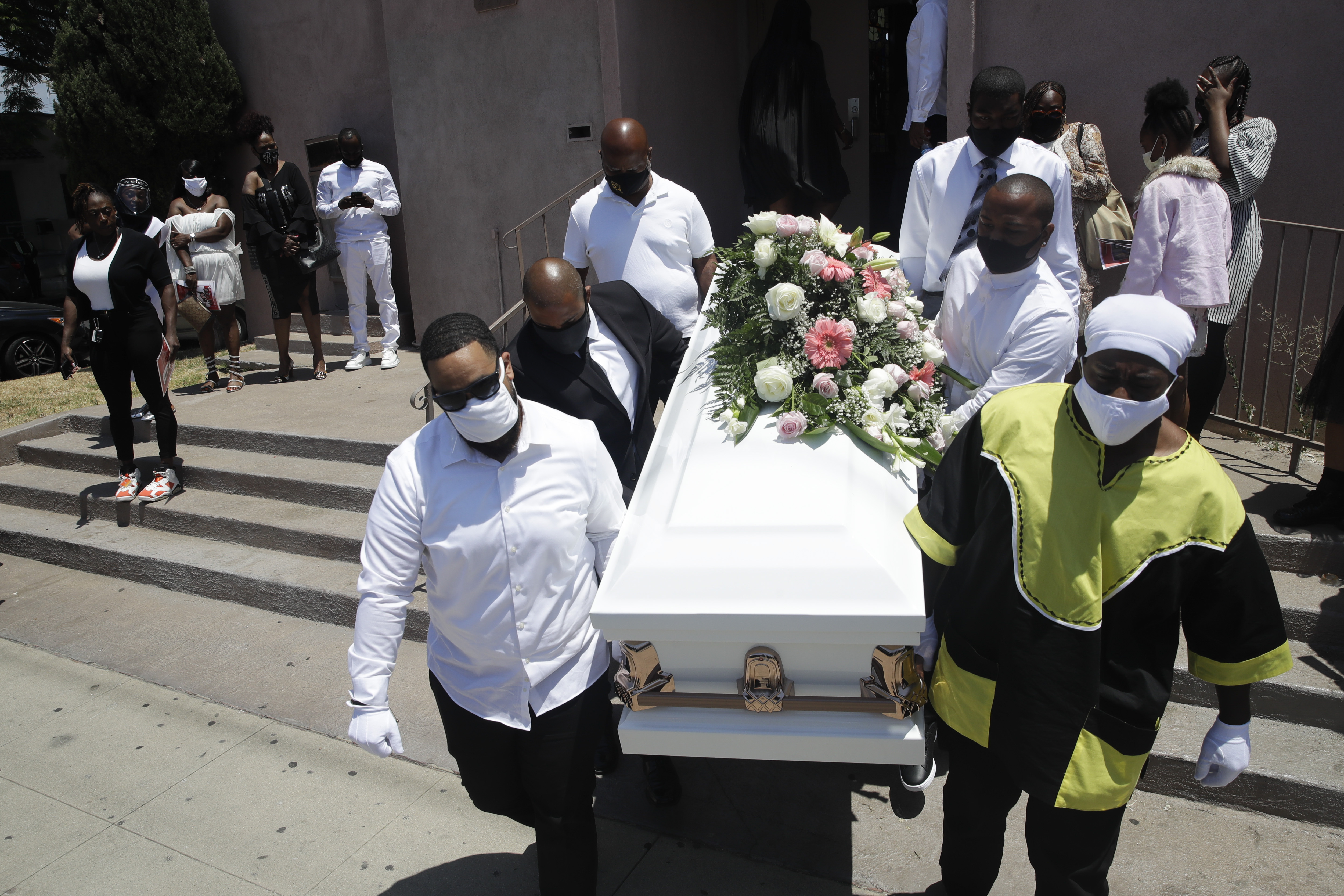 FILE - In this July 21, 2020, file photo, pall bearers carry a casket with the body of Lydia Nunez, who died from COVID-19, after a funeral service at the Metropolitan Baptist Church in Los Angeles. The US death toll from the coronavirus has eclipsed 400,000 in the waning hours in office for President Donald Trump, whose handling of the crisis has been judged by public health experts to be a singular failure. Photo: AP