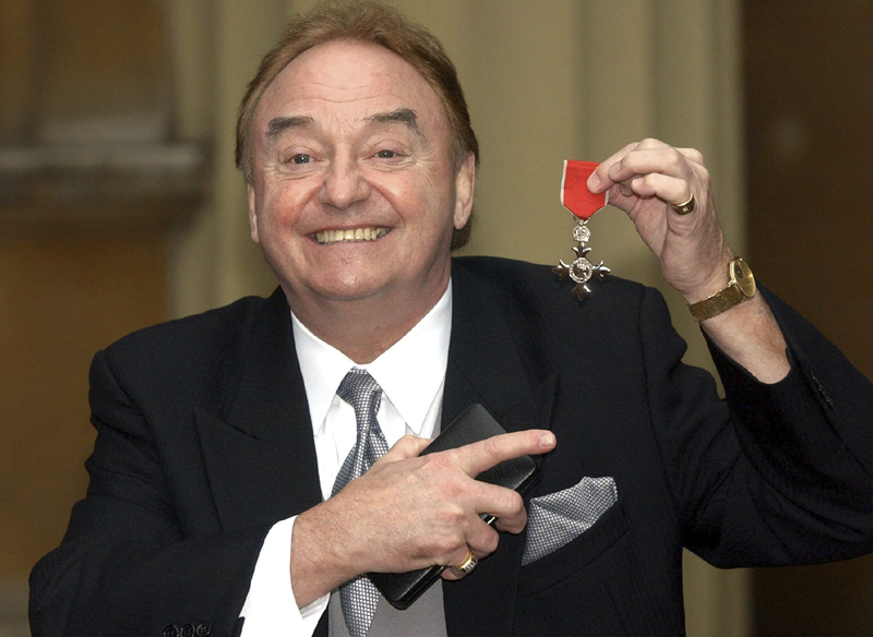 In this Dec. 12, 2003 file photo, Gerry Marsden holds his MBE. Gerry Marsden, the British singer and lead singer of Gerry and the Pacemakers, who was instrumental in turning a song from the Rodgers and Hammerstein musical u0093Carouselu0094 into one of the great anthems in the world of football, has died. He was 78. Photo: Matthew Fearn/PA via AP/ File