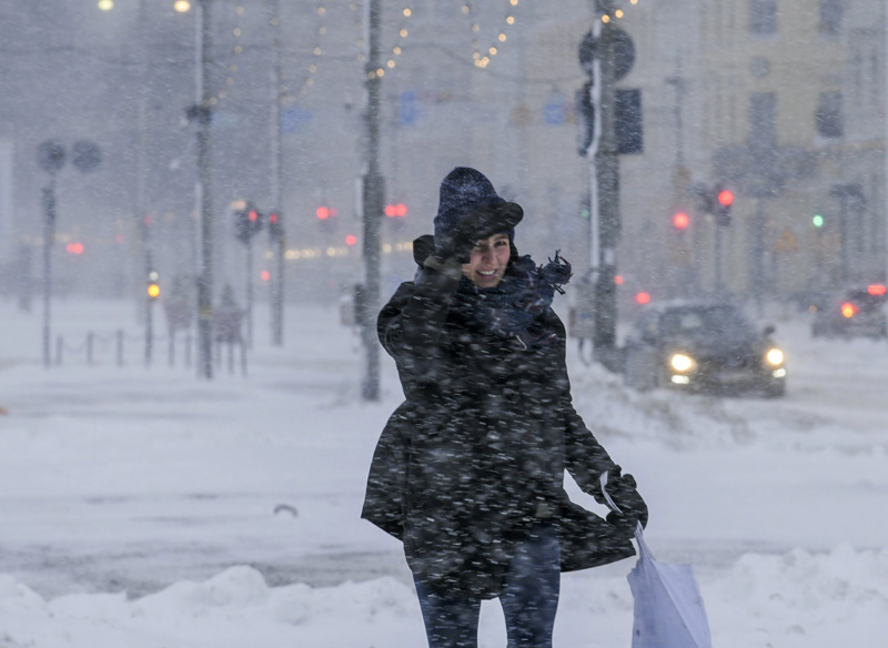 A woman struggles to walk along a street with thick layer of snow in Helsinki, Finland, making all kinds of travel difficult on Tuesday Jan. 12, 2021. Photo: Markku Ulander/Lehtikuva via AP