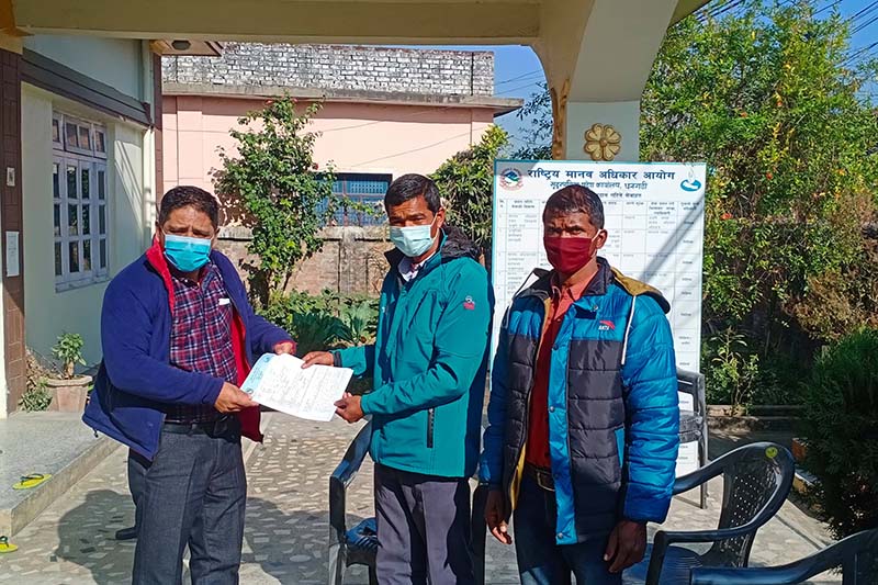 Haliya community member handing over a file of complaints and demands to Chief at National Human Rights Commission, Mandev Joshi, in Dhangadhi Sub-metropolitan City, Kailali district, on Friday, January 8, 2021. Photo: Prakash Singh/THT