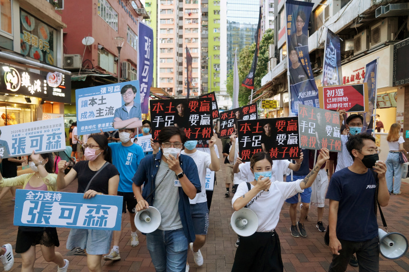 FILE PHOTO: Sam Cheung Ho-sum and Wong Ji-yuet march on a street to campaign for the primary election aimed at selecting democracy candidates for the September election, in Hong Kong, China July 12, 2020.  Photo: Reuters
