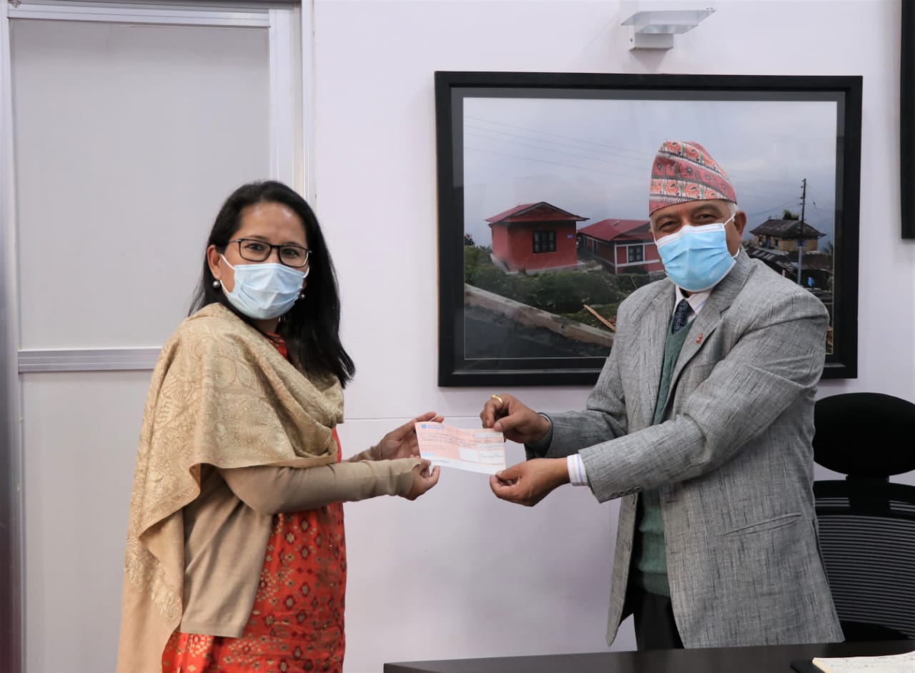 Namgya Khampa, deputy chief of mission at the Embassy of India in Nepal handing RS 306 million cheque to Shushil Gyawali, chief executive officer of National Reconstruction Authority towards reconstruction of earthquake affected schools in Nepal, on Wednesday, January 6, 2021. Photo Courtesy: India In Nepal/ twitter