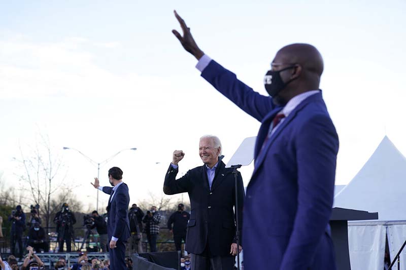 President-elect Joe Biden campaigns in Atlanta, on Monday, Jauary. 4, 2021, for Senate candidates Raphael Warnock, right, and Jon Ossoff, left. Photo: AP