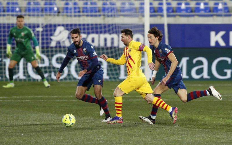 Barcelona's Lionel Messi in action with Huesca's Pablo Insua and Pedro Mosquera during the La Liga Santander between SD Huesca and FC Barcelona, at Estadio El Alcoraz, in Huesca, Spain, on January 3, 2021. Photo: Reuters