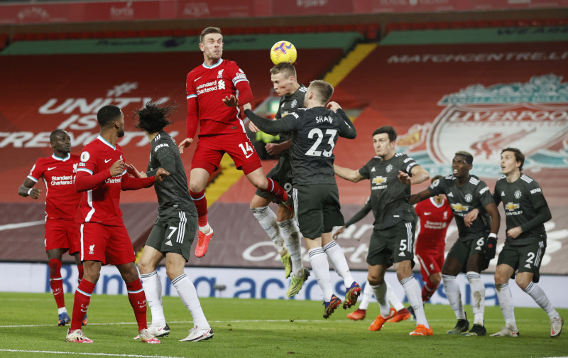 Liverpool's Jordan Henderson in action with Manchester United's Scott McTominay and Luke Shaw  during the Premier League match  between Liverpool and Manchester United, at Anfield, in Liverpool, Britain, on January 17, 2021. Photo: Pool via Reuters