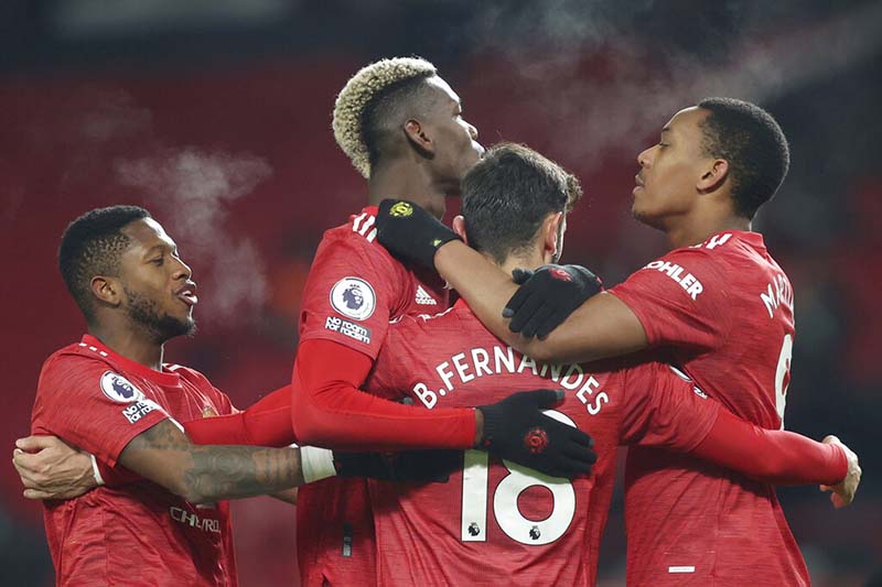 Manchester United's Bruno Fernandes, (18), celebrates with teammates after scoring his sides 2nd goal of the game from the penalty spot during the English Premier League soccer match between Manchester United and Aston Villa at Old Trafford in Manchester, England, on Friday, January 1, 2021. Photo: Carl Recine/ Pool via AP