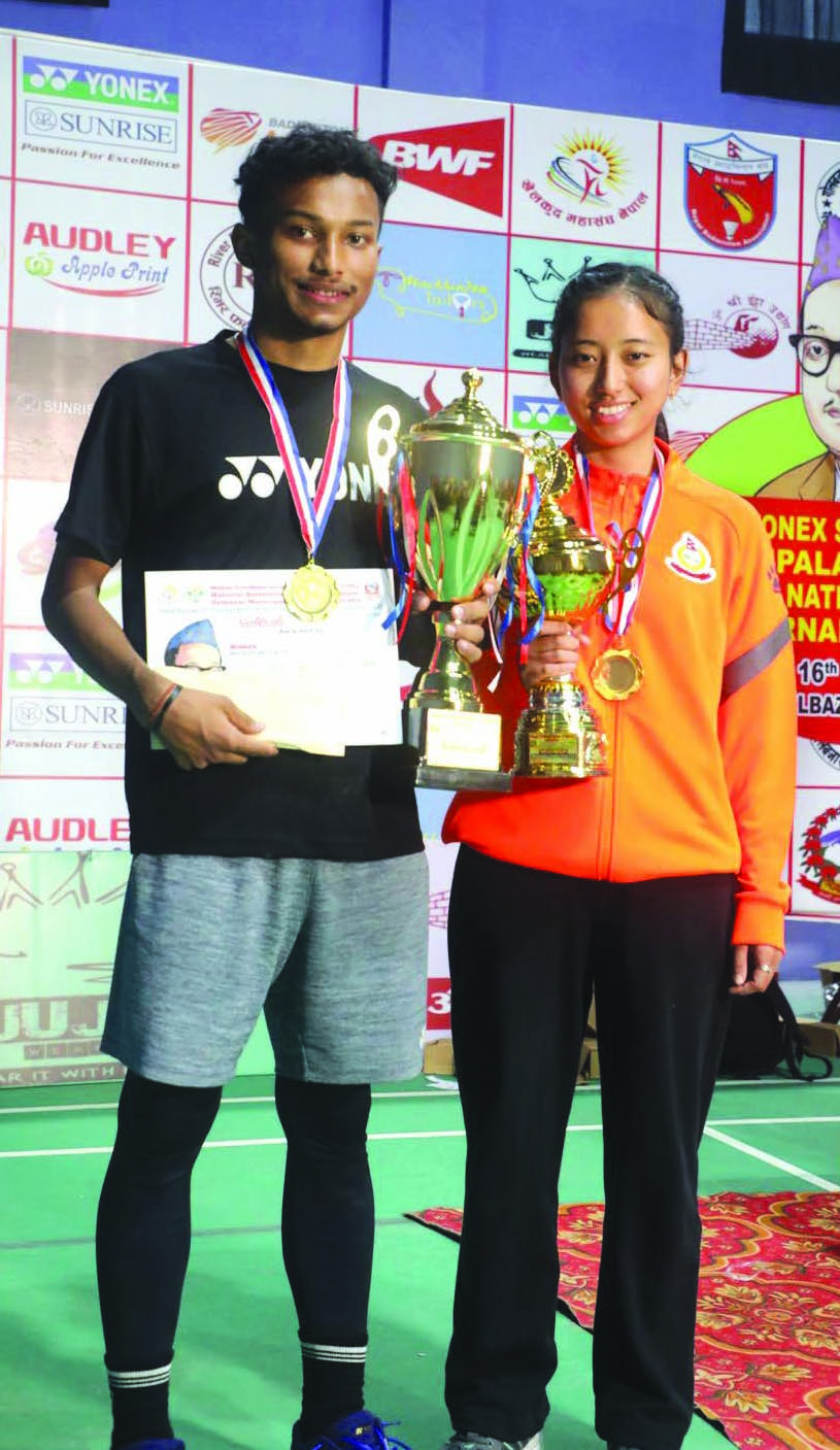 Prince Dahal and Jessica Gurung hold the trophies after the Yonex Sunrise 10th Pushpalal Memorial National Ranking Badminton Tournament on Sunday.