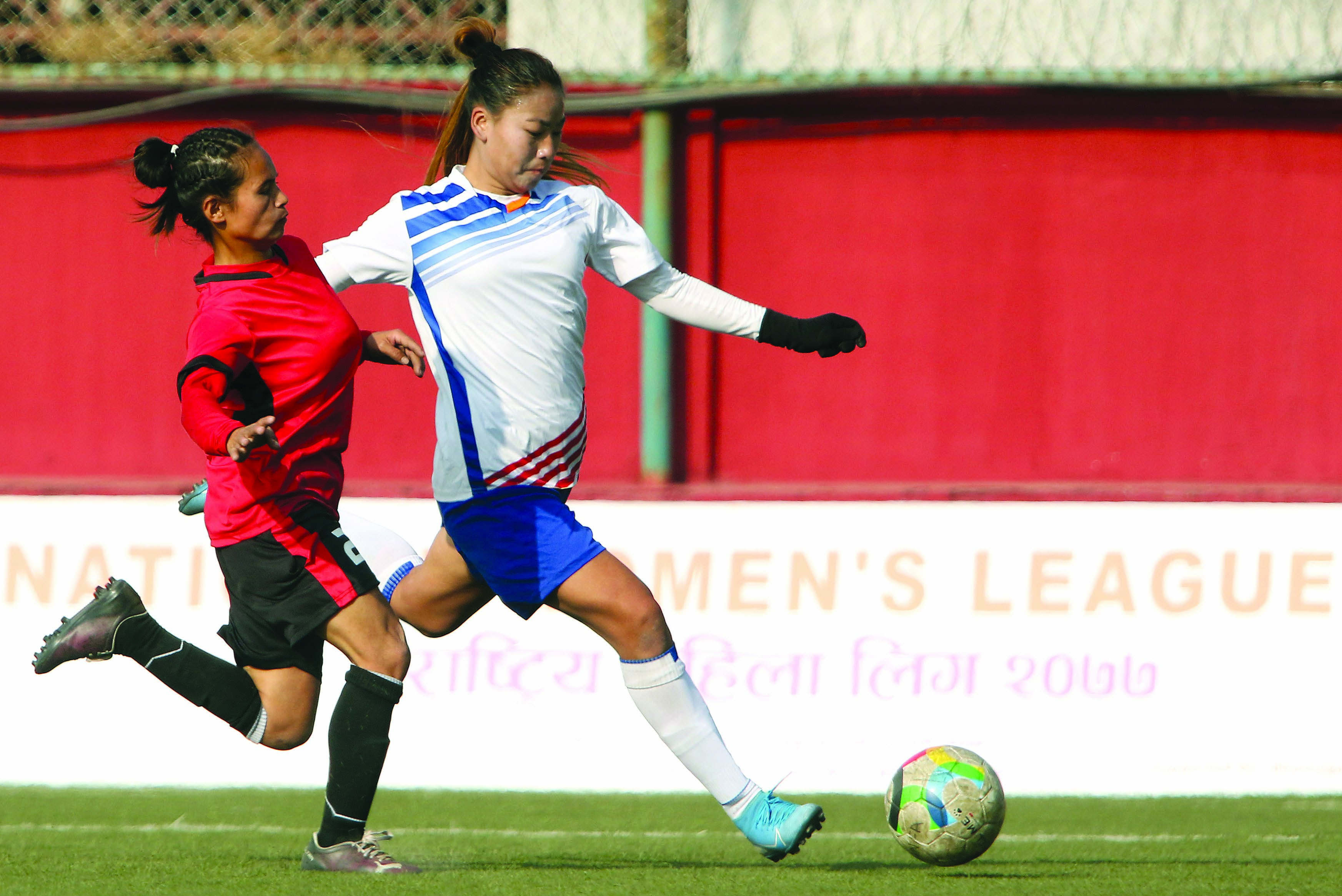 Chandrapur Municipalityu2019s Sabita Rana Magar (right) shoots the ball under pressure from Chaudandigadhi Municipalityu2019s Sabita Tamang during their National Womenu2019s League match at the ANFA Complex grounds in Lalitpur on Monday. Photo: Udipt Singh Chhetry / THT