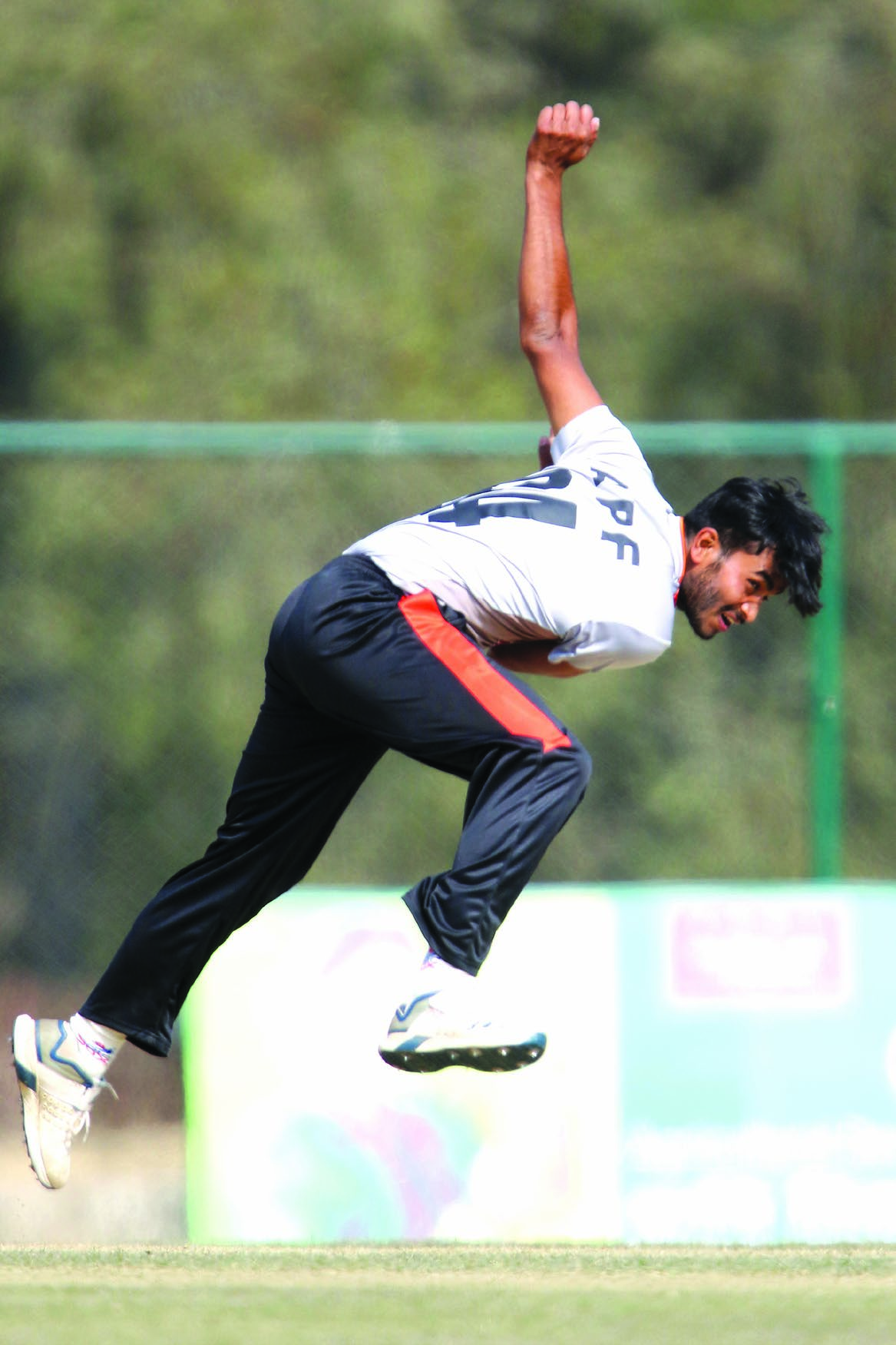 Nepal APF Clubu2019s Kamal Singh Airee bowls against Tribhuvan Army Club during their PM Cup match in Kathmandu on Monday. Photo: THT