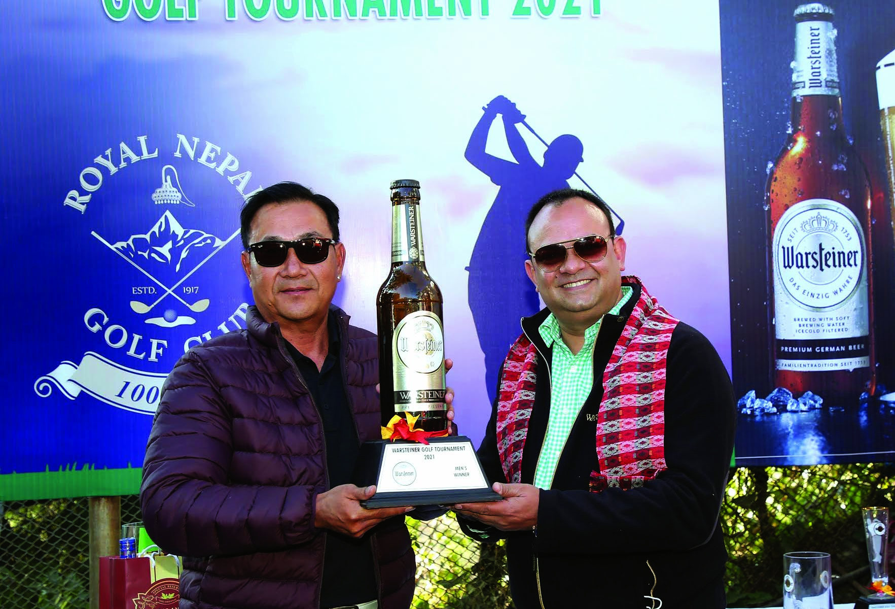 Jawalakhel Group of Industries MD Raj Bahadur Shah (right) handing over the trophy to Jiwan Limbu after the Warsteiner Golf Tournament in Kathmandu on Saturday.
